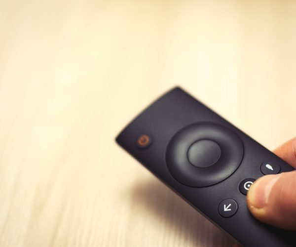TV remote control in hand